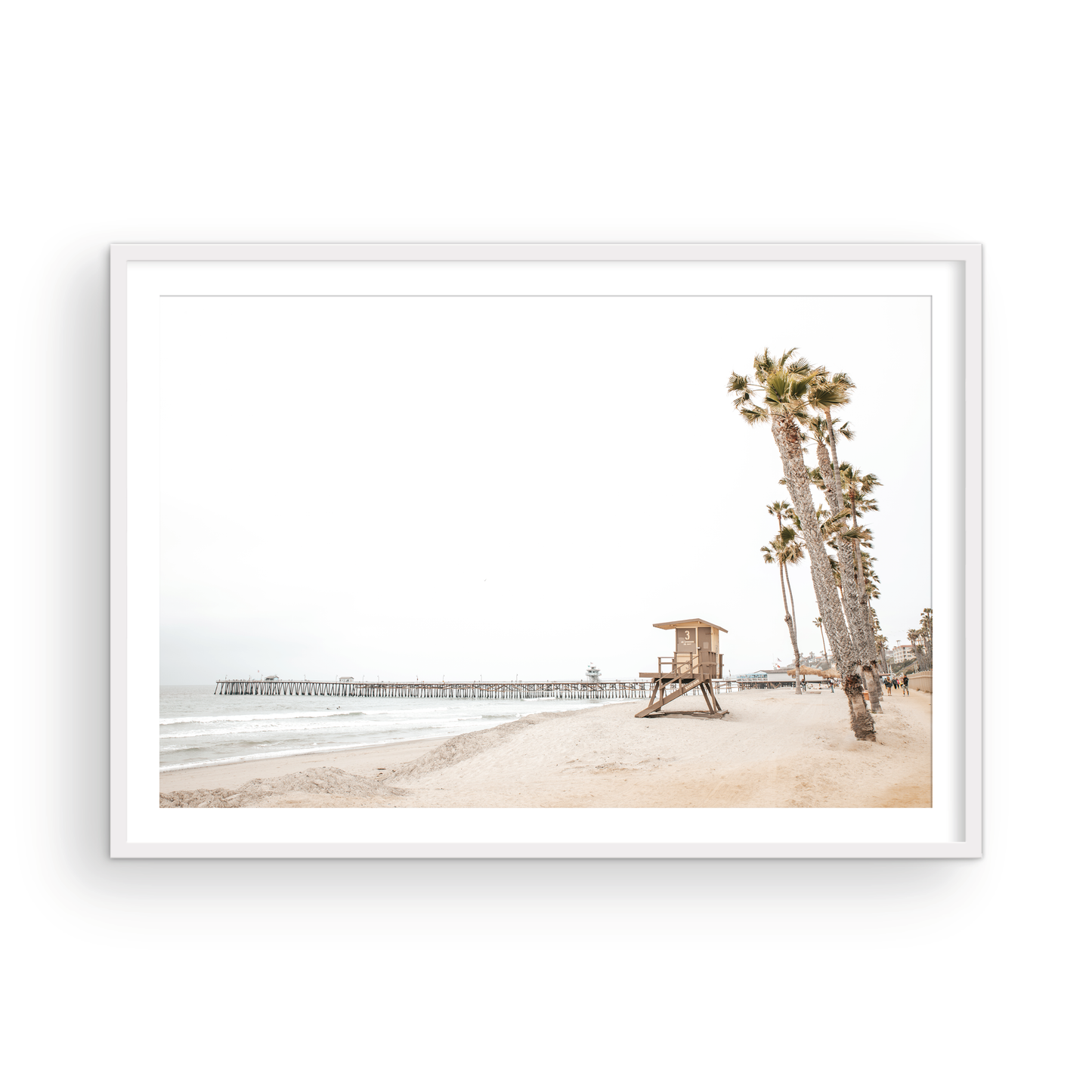 A wide landscape coastal photography view of San Clemente State Beach in Southern California, featuring a row of tall palm trees, a lifeguard tower, and people enjoying the calm beach. This image evokes Summer Vibes Wall Art and tropical beach print aesthetics. Photograph in minimalist mock up.