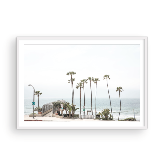 Landscape coastal photography of T-Street Beach in San Clemente, with tall palm trees and a unique pier structure leading to the ocean. A perfect horizontal California coast print. Photograph in minimalist mock up