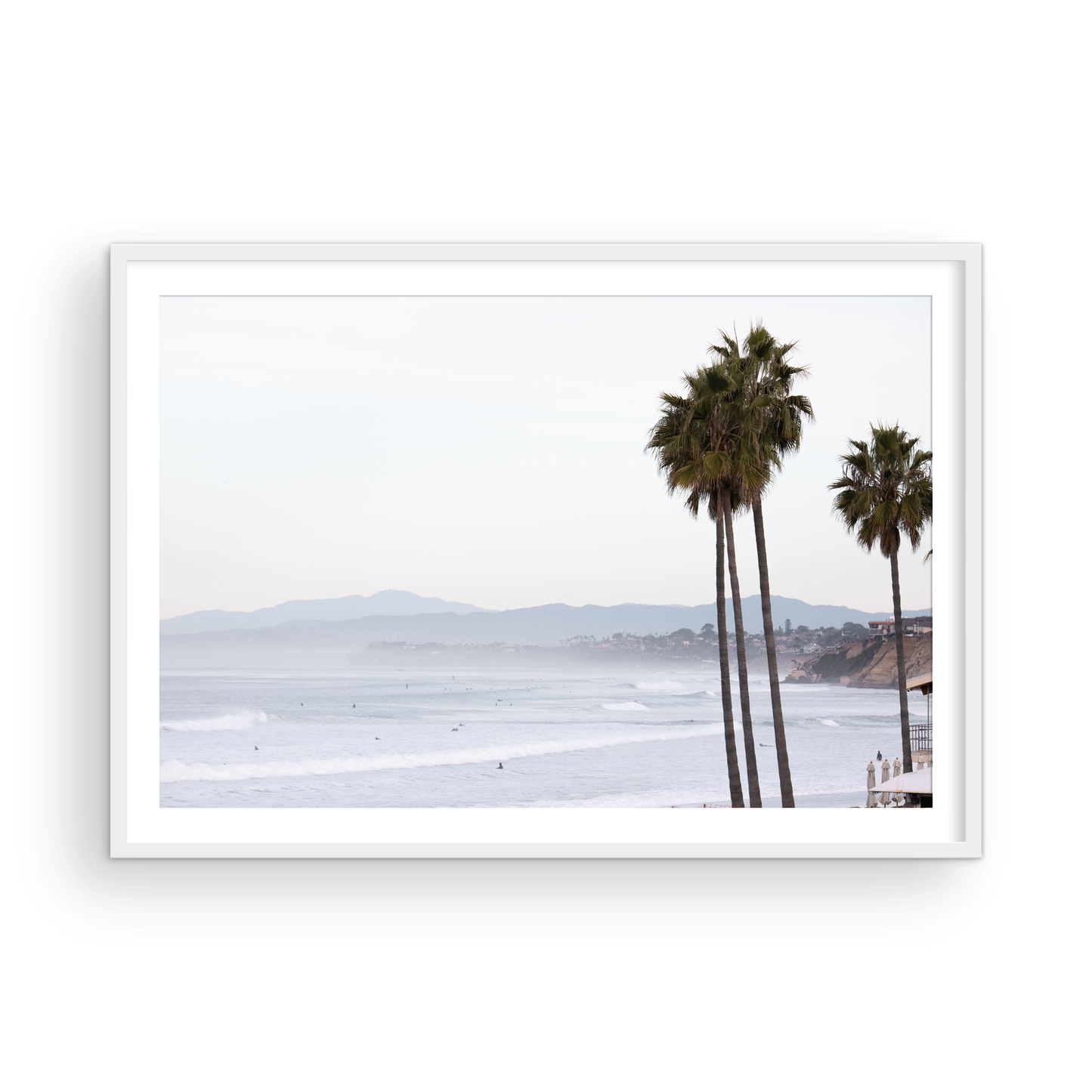Landscape San Diego beach print showing a seascape with gentle ocean waves in the water and palm trees in the foreground. Photograph in minimalist mock up.