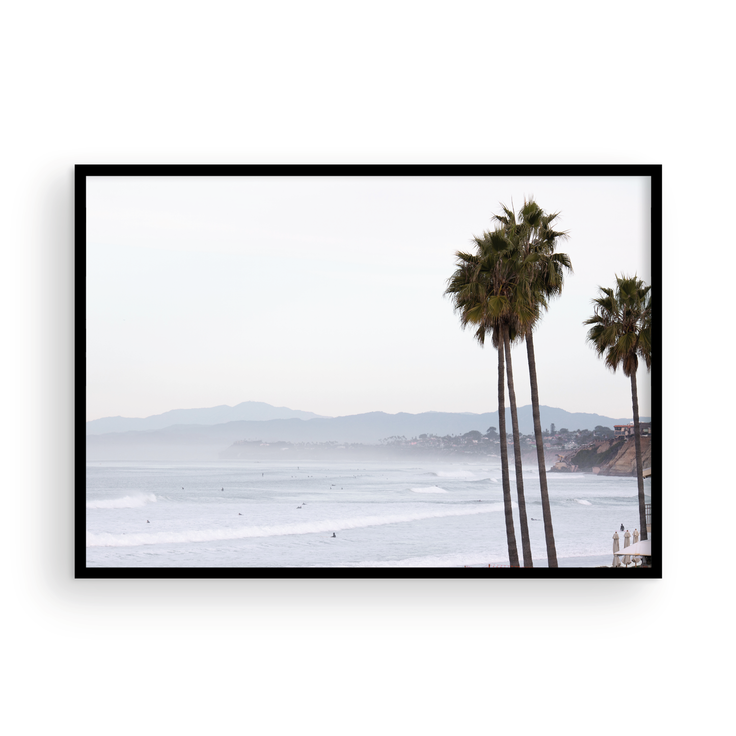Landscape San Diego beach print showing a seascape with gentle ocean waves in the water and palm trees in the foreground. Photograph in minimalist mock up.