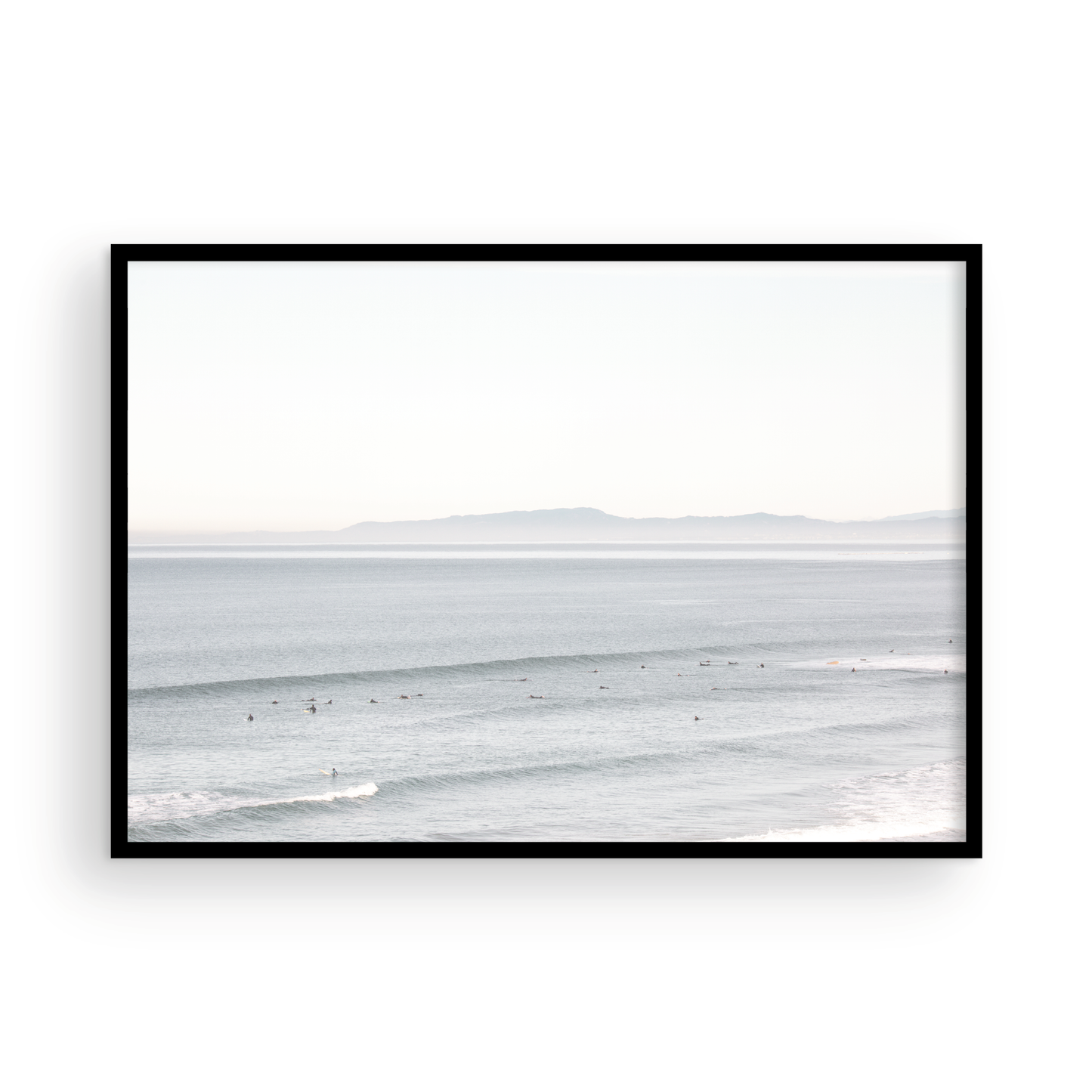Coastal photography featuring a calm ocean scene with gentle waves and a hazy horizon line, predominantly in blue and white tones. Photograph in minimalist mock up.