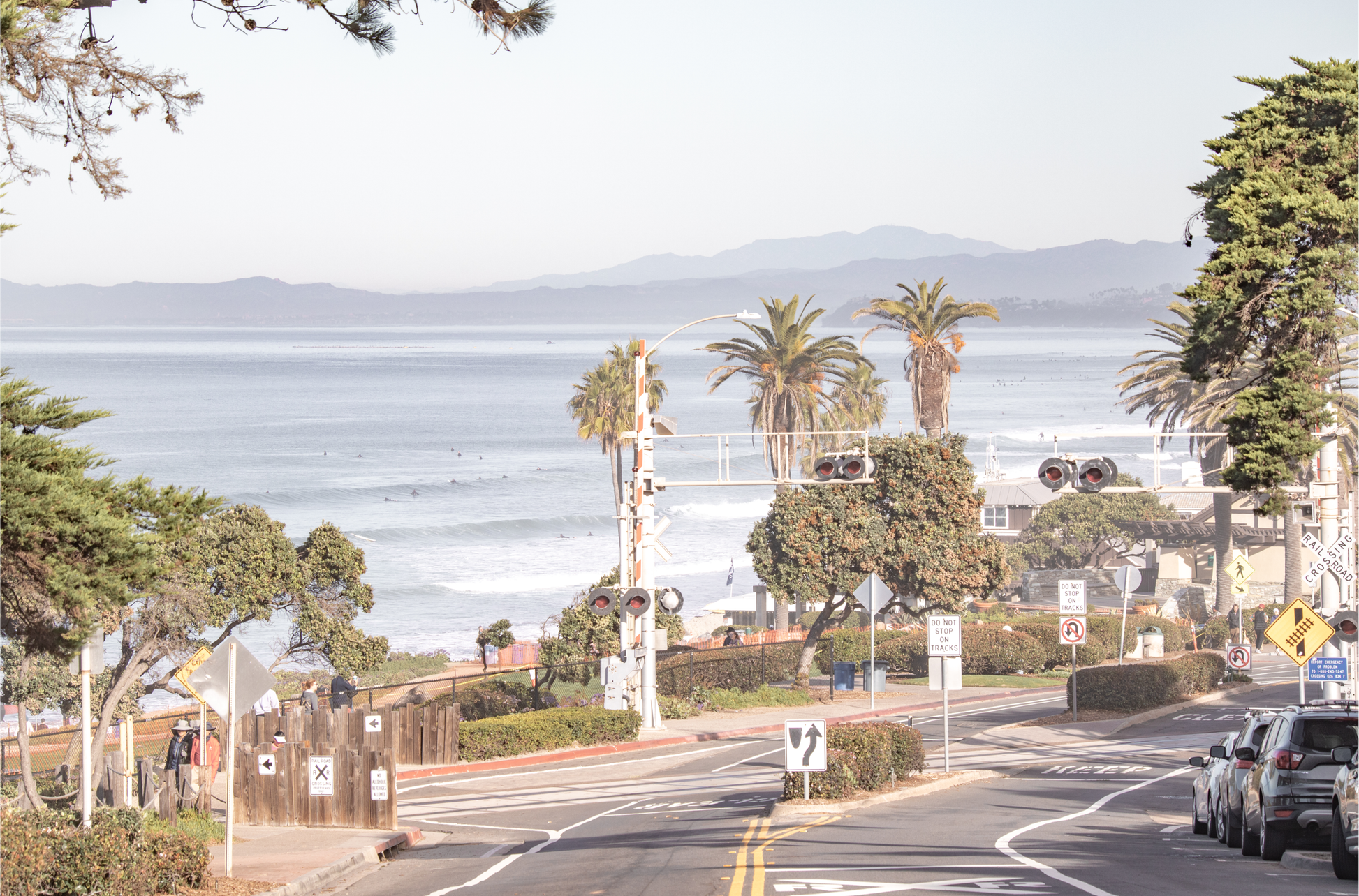 Coastal fine art photography print featuring a scenic view of a coastal road with palm trees, ocean in the background.