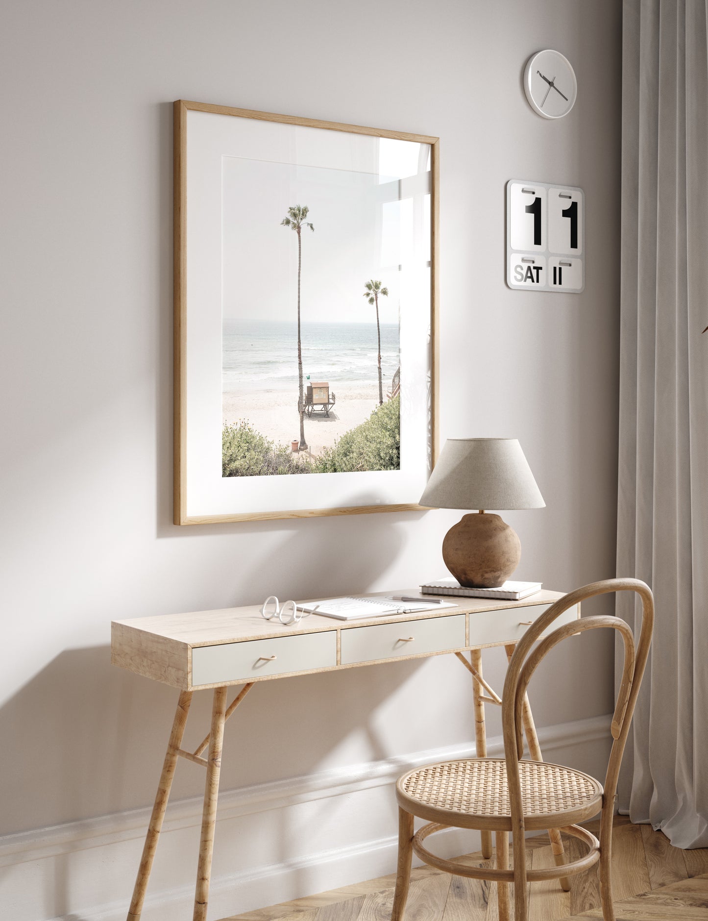Vertical beach wall art featuring a lifeguard tower nestled between two tall palm trees on a sunny California beach, capturing a serene beach vibe. Photograph in minimalist mock up.