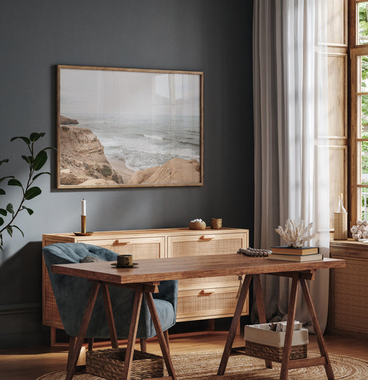 Fine art of Sunset Cliffs, San Diego California horizontal print of hazy high-angle landscape beach photography captures a light blue ocean meeting tall tan and brown cliffs rise as iconic coastal scenery. Photograph in minimalist mock up.