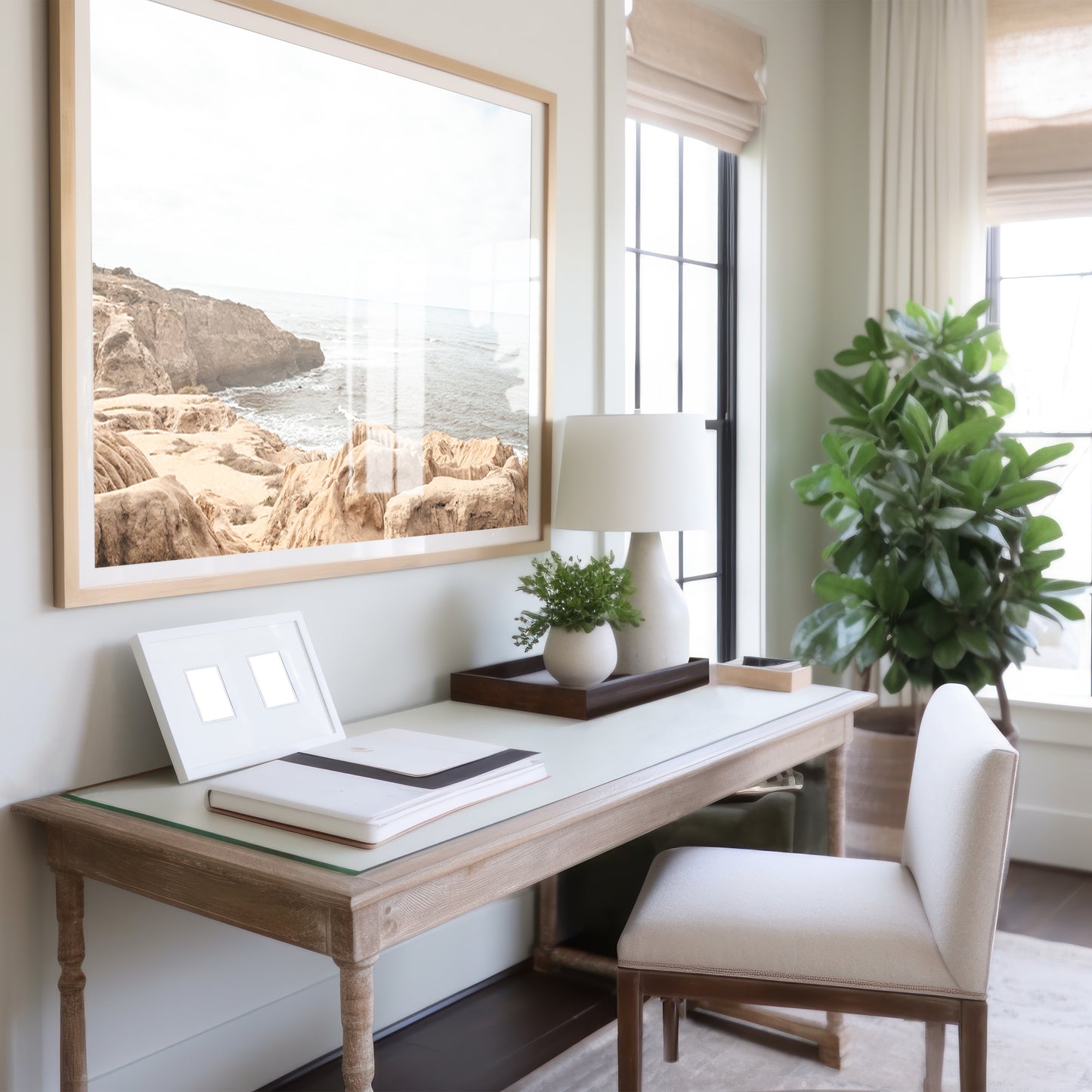 Fine art of Sunset Cliffs, San Diego California horizontal print of hazy high-angle landscape beach photography captures a light blue ocean meeting tall tan and brown cliffs rise as iconic coastal scenery. Photograph in minimalist art mock up.