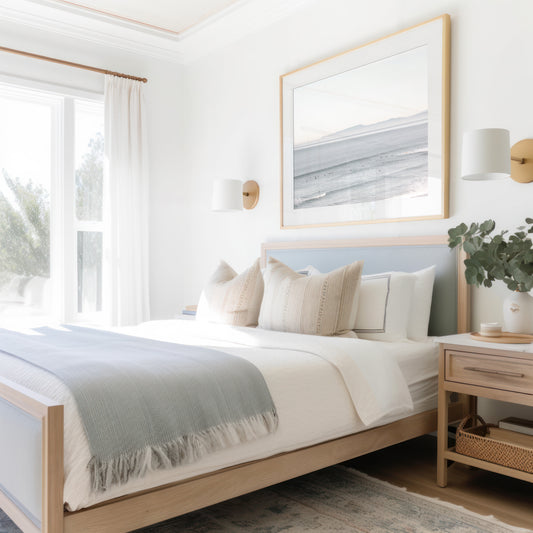 Coastal photography featuring a calm ocean scene with gentle waves and a hazy horizon line, predominantly in blue and white tones. Photograph in minimalist mock up.