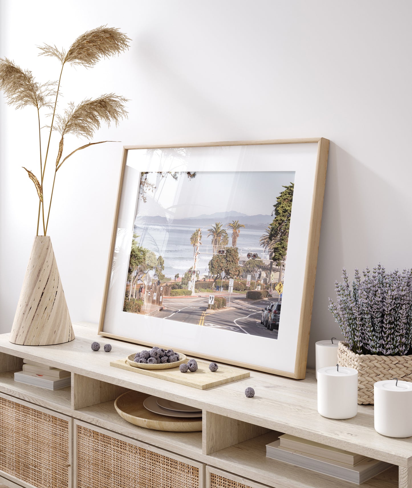 Coastal fine art photography print featuring a scenic view of a coastal road with palm trees, ocean in the background. Photograph in minimalist mock up.