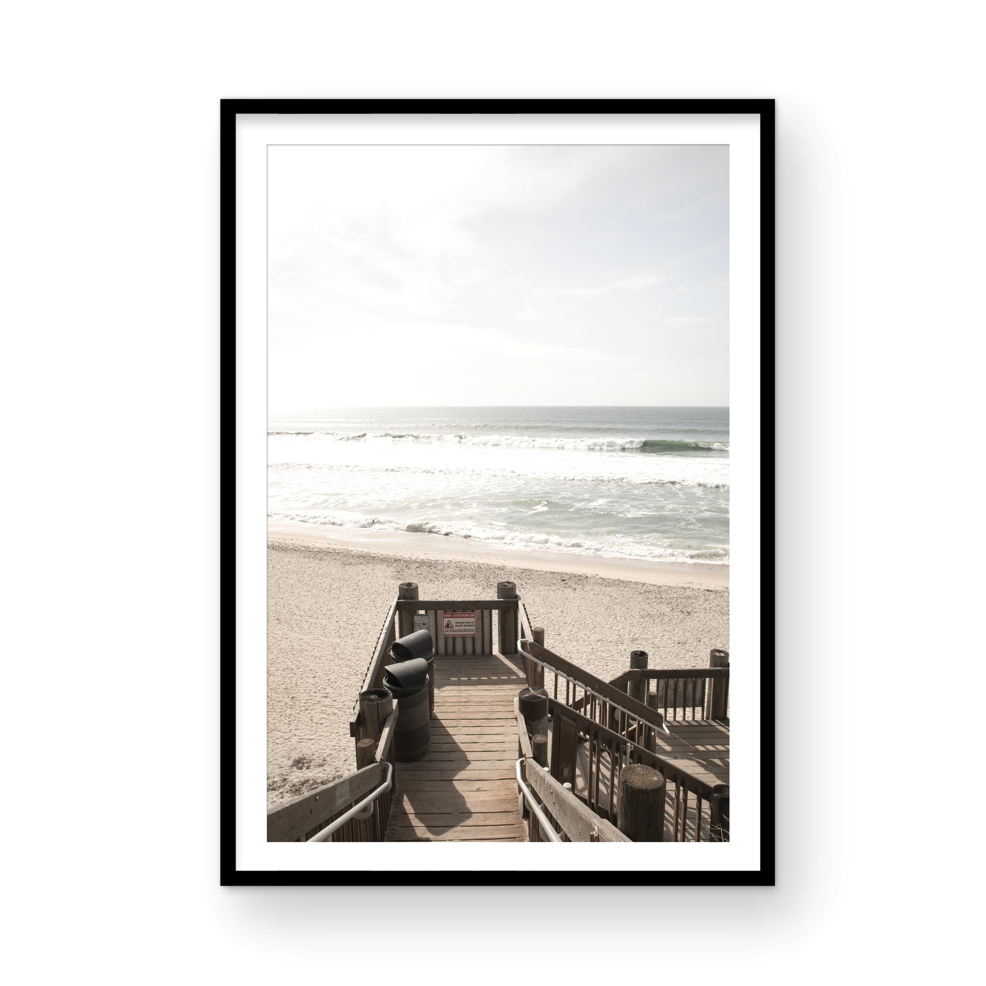 Vertical coastal wall print featuring a stairway leading down to a beach, overlooking an ocean view. Photograph in minimalist mock up.