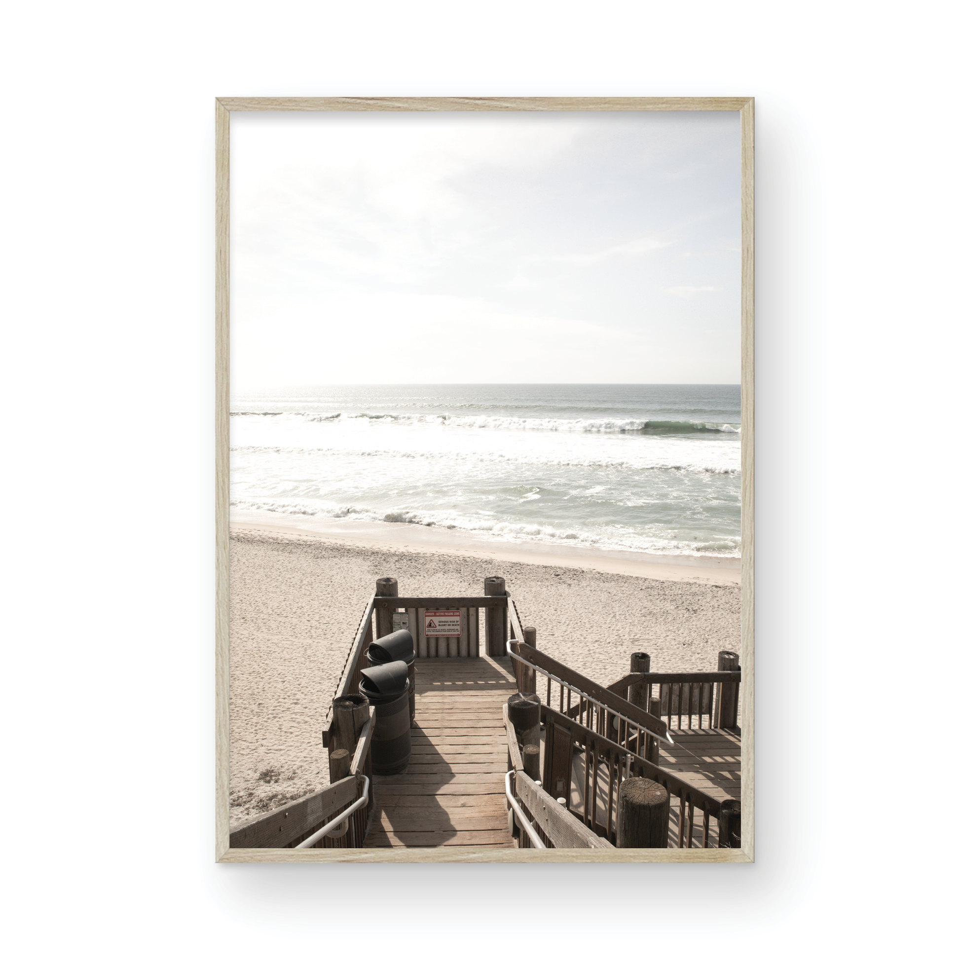 Vertical coastal wall print featuring a stairway leading down to a beach, overlooking an ocean view. Photograph in minimalist mock up.