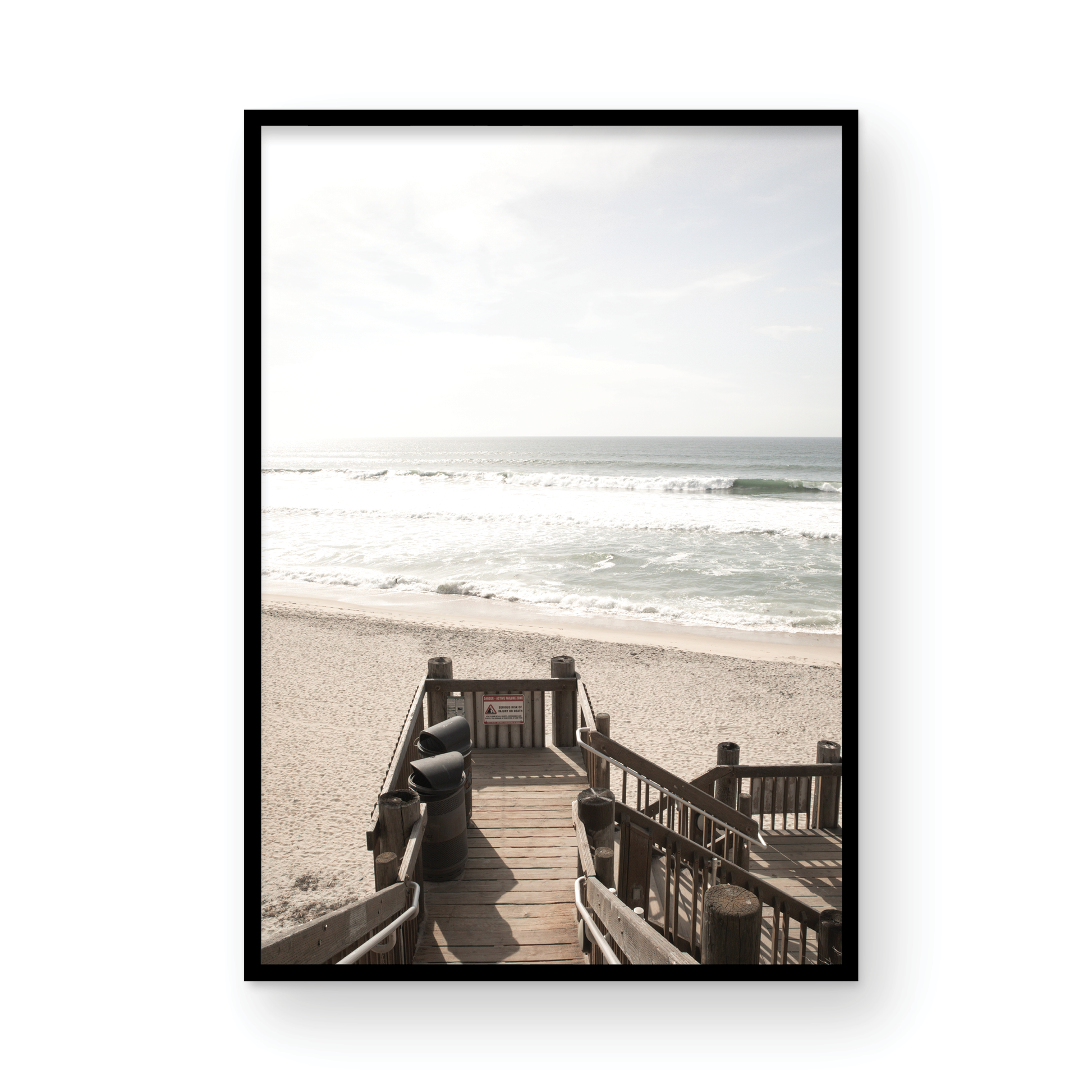 Vertical coastal wall print featuring a stairway leading down to a beach, overlooking an ocean view. Photograph in minimalist mock up.