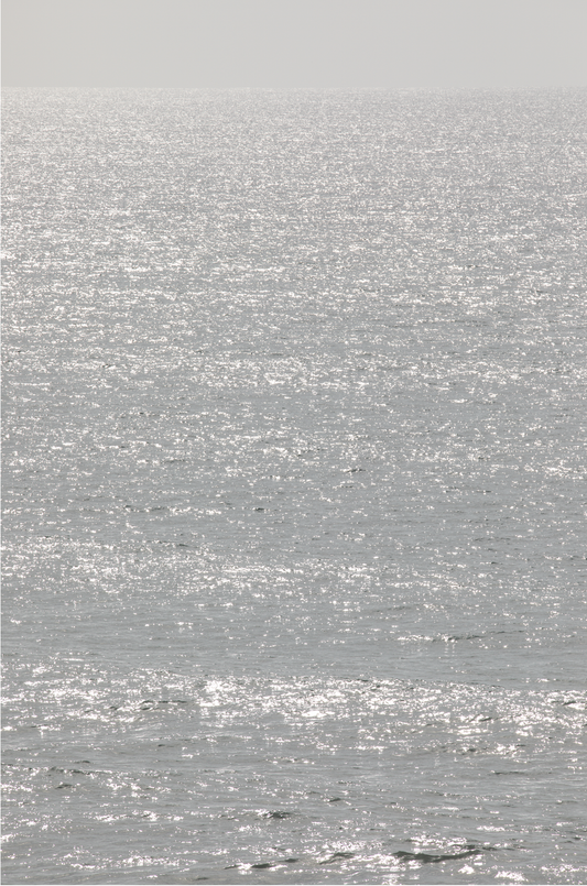 Minimalist ocean art print of a bright, sunlit ocean surface, creating a sparkling vertical seascape.