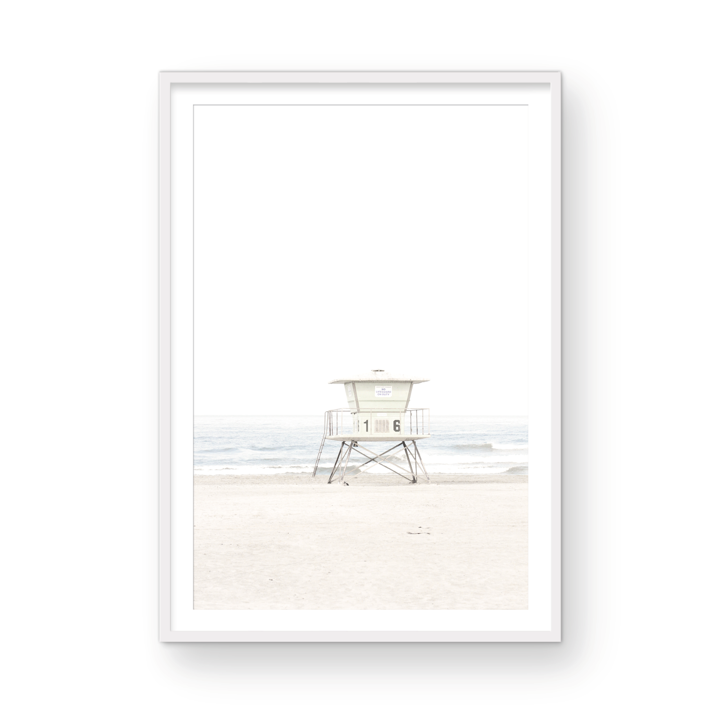 A vertical beach art close-up of a pale lifeguard tower (16), with ocean waves in the distance, on a San Diego Beach. Photograph in minimalist mock up.