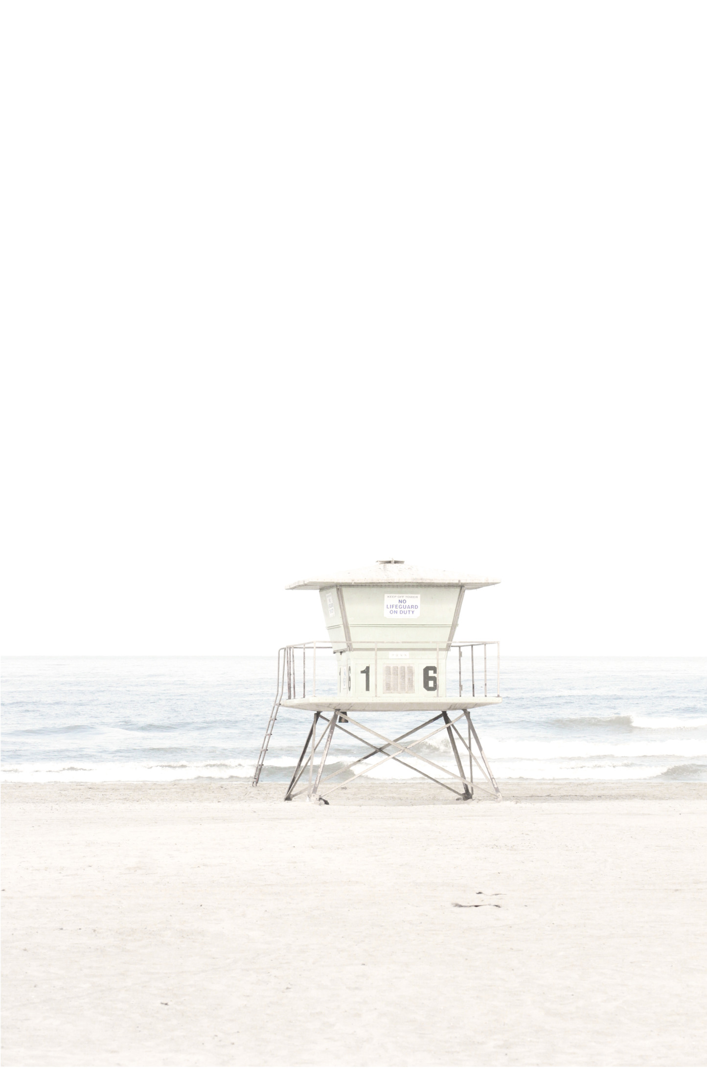 A vertical beach art close-up of a pale lifeguard tower (16), with ocean waves in the distance, on a San Diego Beach.