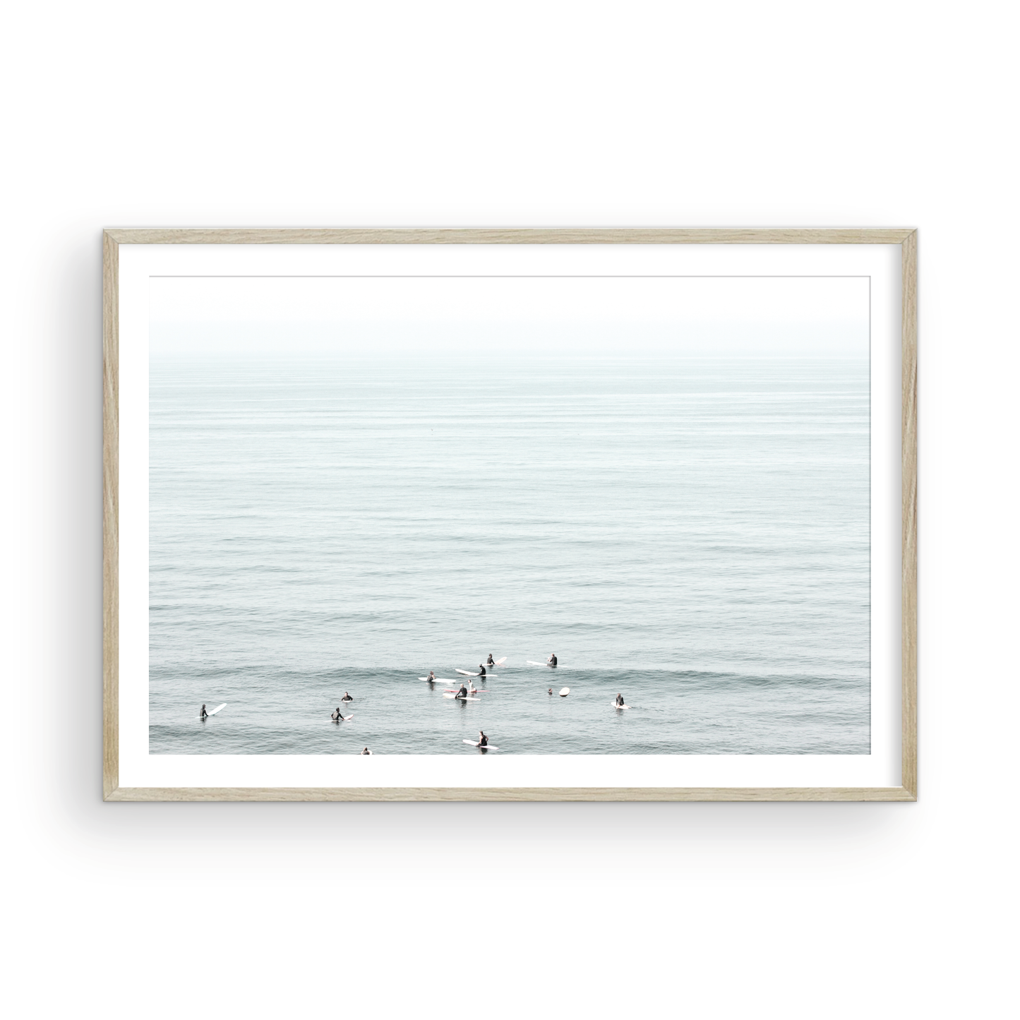 Horizontal surf art showing multiple surfers waiting in the calm ocean water for waves, with a hazy Southern California coastline in the distance. This minimalist surf print captures authentic surf vibes. Photograph in minimalist mock up.