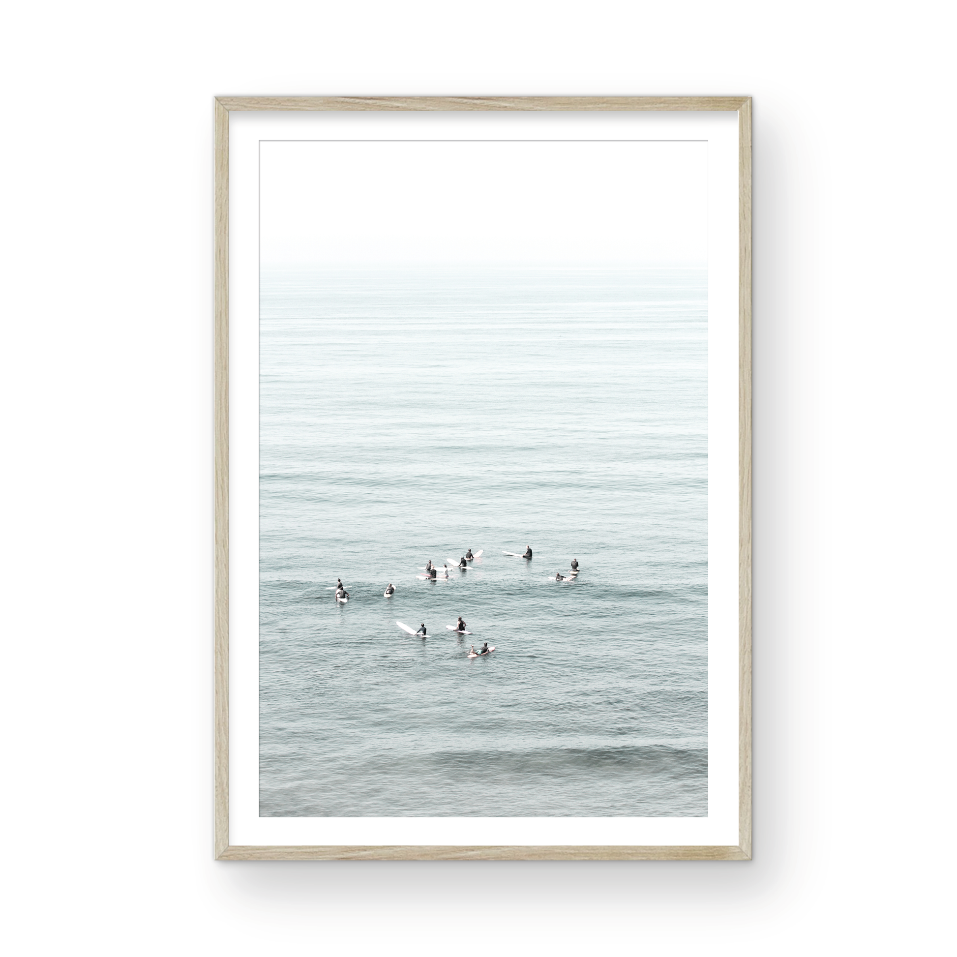 Vertical surf art showing multiple surfers waiting in the calm ocean water for waves, with a hazy Southern California coastline in the distance. This minimalist surf print captures authentic surf vibes. Photograph in minimalist mock up.