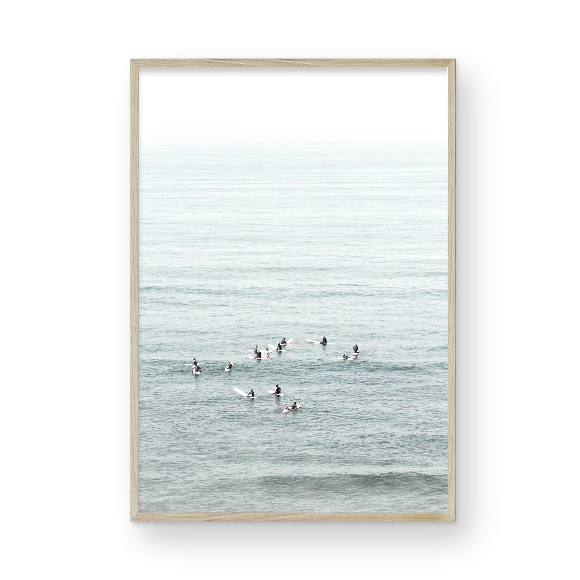 Vertical surf art showing multiple surfers waiting in the calm ocean water for waves, with a hazy Southern California coastline in the distance. This minimalist surf print captures authentic surf vibes. Photograph in minimalist mock up.