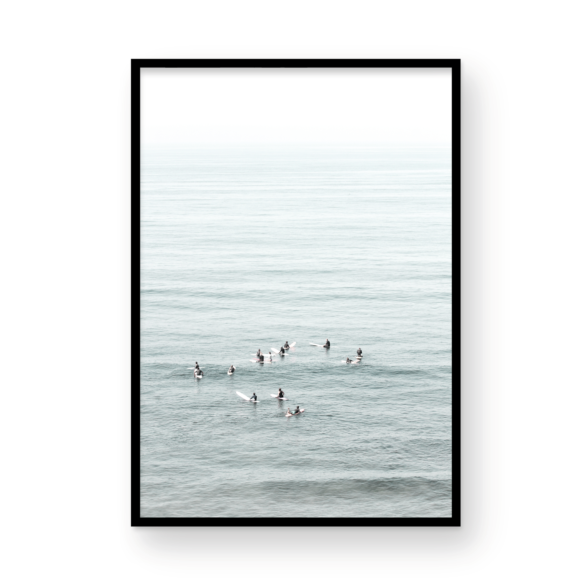 Vertical surf art showing multiple surfers waiting in the calm ocean water for waves, with a hazy Southern California coastline in the distance. This minimalist surf print captures authentic surf vibes. Photograph in minimalist mock up.