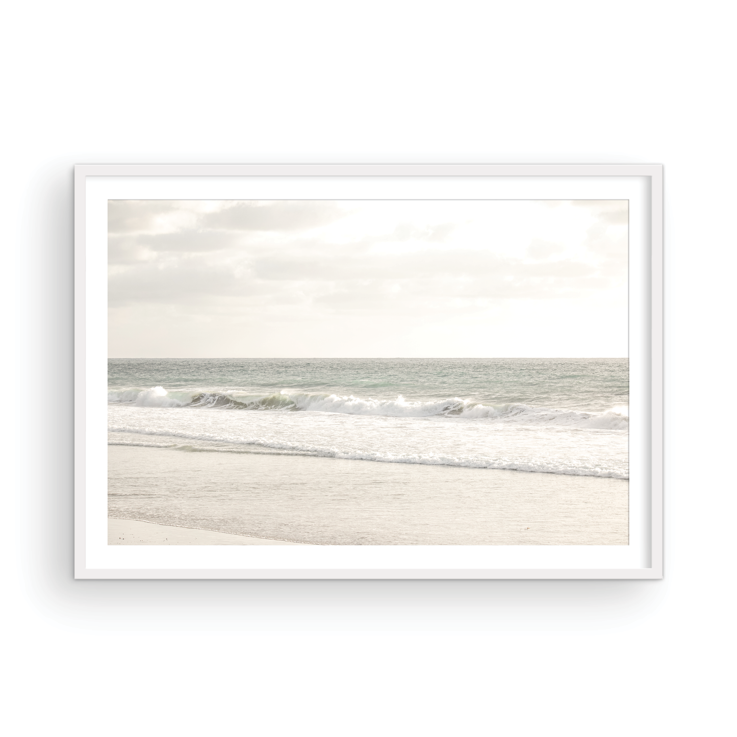 Minimalist ocean print of gentle ocean waves rolling onto a sandy shoreline at Moonlight Beach, San Diego, under a bright, soft sky. This calm beach print provides a serene seascape. Photograph in minimalist mock up.