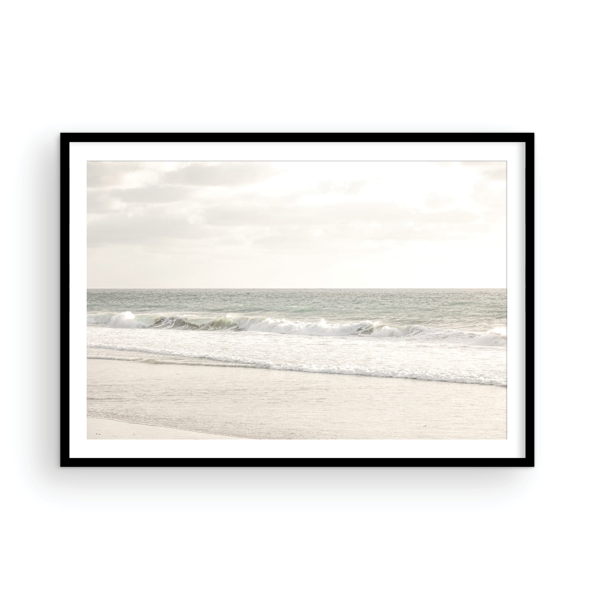 Minimalist ocean print of gentle ocean waves rolling onto a sandy shoreline at Moonlight Beach, San Diego, under a bright, soft sky. This calm beach print provides a serene seascape. Photograph in minimalist mock up.