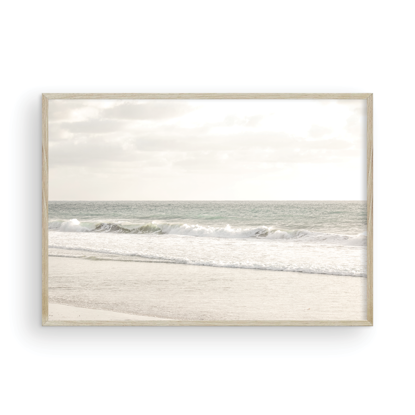 Minimalist ocean print of gentle ocean waves rolling onto a sandy shoreline at Moonlight Beach, San Diego, under a bright, soft sky. This calm beach print provides a serene seascape. Photograph in minimalist mock up.