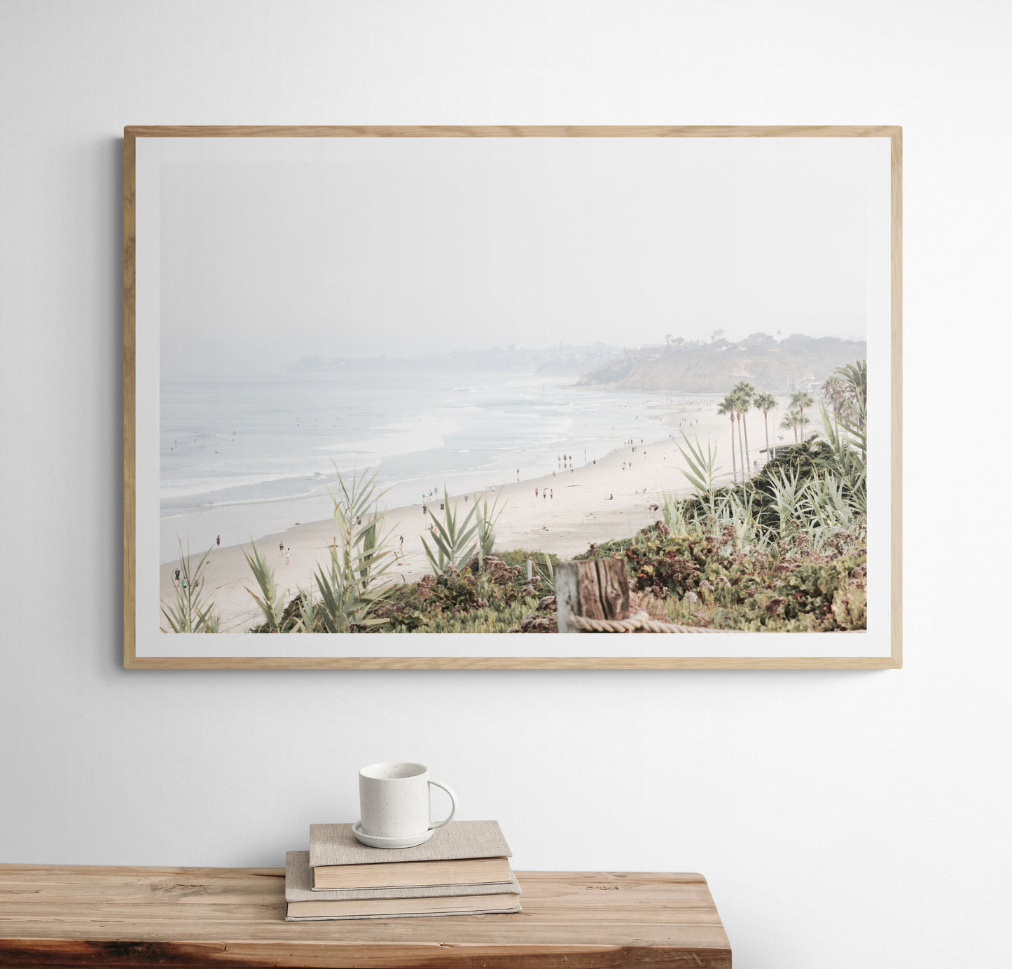 Landscape San Diego beach print showing seascape with gentle ocean waves in the water near a sandy cliff. Photograph in minimalist mock up.
