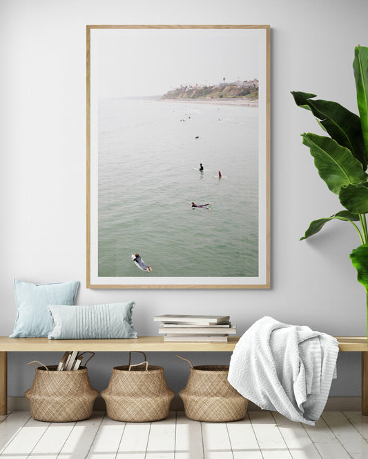 Vertical surf print of surfers floating in the ocean waves at a Southern California beach, with a distant coastline. This image captures surfing art and a minimalist surf vibe. Photograph in minimalist mock up.