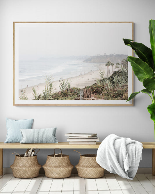 Landscape San Diego beach print showing seascape with gentle ocean waves in the water near a sandy cliff. Photograph in minimalist mock up.