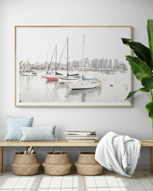 A horizontal San Diego print showcasing numerous sailboats in San Diego Harbor with the city skyline in the background. This modern coastal print embodies the Southern California coastal photography, perfect for a large beach wall art. Photograph in minimalist mock up.