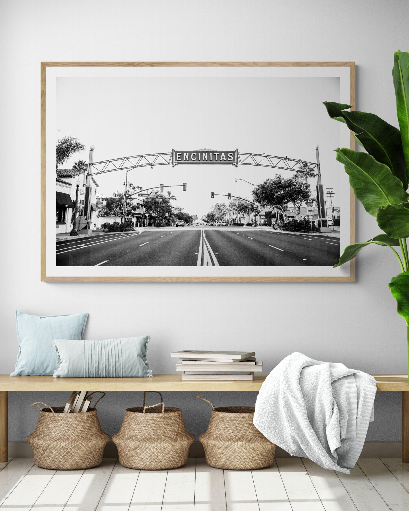 A black and white photograph of a street sign that reads 'Encinitas' with a background of a city street. Photograph in minimalist mock up.