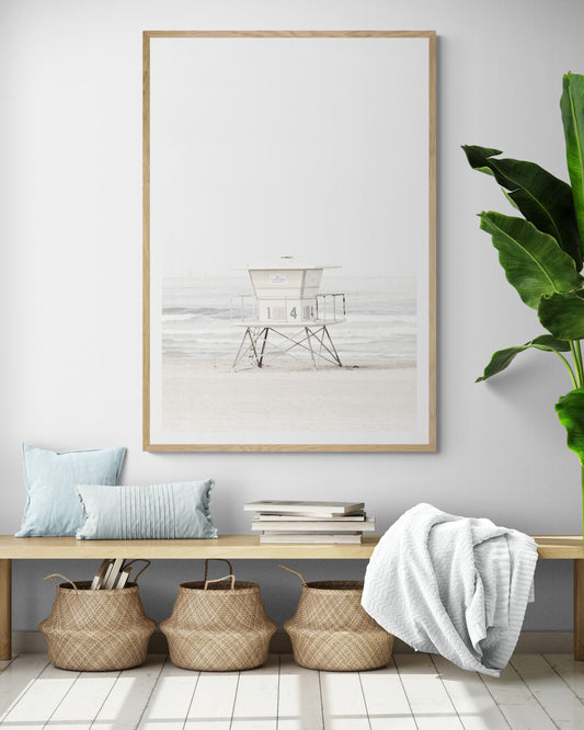 A vertical beach art close-up of a pale lifeguard tower (14), with ocean waves in the distance, on a San Diego Beach. Photograph in minimalist mock up.