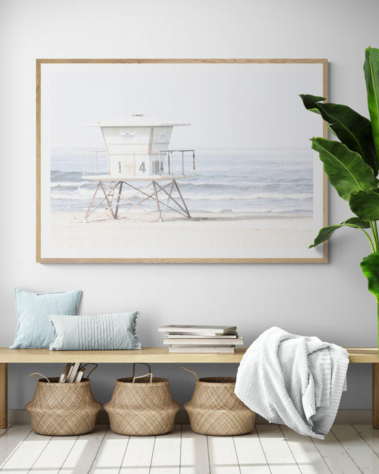A horizontal beach art close-up of a pale lifeguard tower (14), with ocean waves in the distance, on a San Diego Beach. Photograph in minimalist mock up.