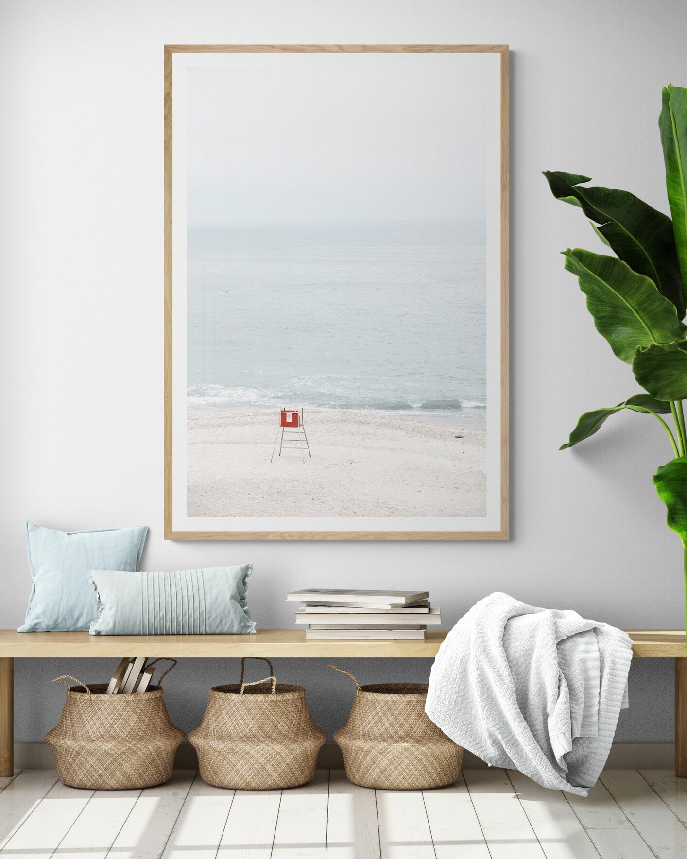 Vertical coastal photography featuring a red and white lifeguard chair and a calm ocean background, located in Laguna California. Photograph in minimalist mock up.