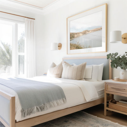 Framed photo of: Drakes Bay 7383 displayed above a bed in a coastal bedroom.