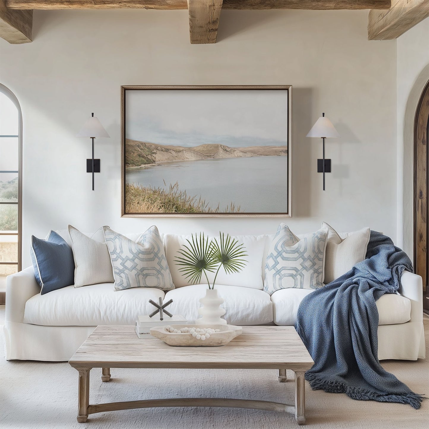 Framed photo of: Drakes Bay 7383 displayed above a couch in a coastal living room.