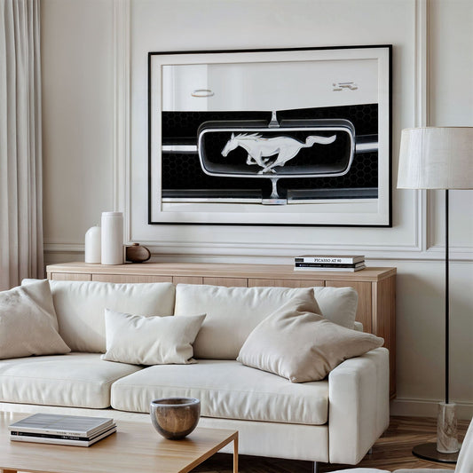 Framed photo of: Ford 8021 displayed above a couch.