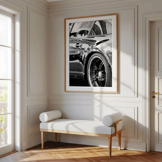 Framed photo of: Porsche 8346 displayed on a wall above a bench in a luxury hallway.