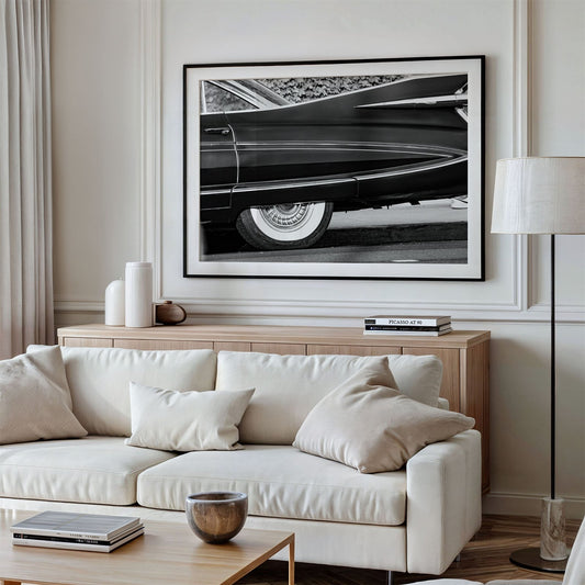 Framed photo of: Cadillac Fleetwood 7961 displayed above a couch in a modern living room.
