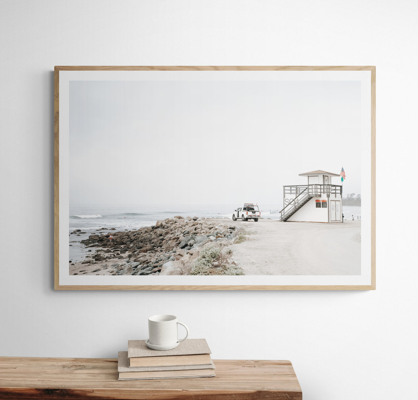 Landscape beach photography of Salt Creek Beach, with lifeguard tower SC 4 in the foreground, and many people enjoying the beach and ocean in the distance. A beach vibes print. Photograph in minimalist mock up.