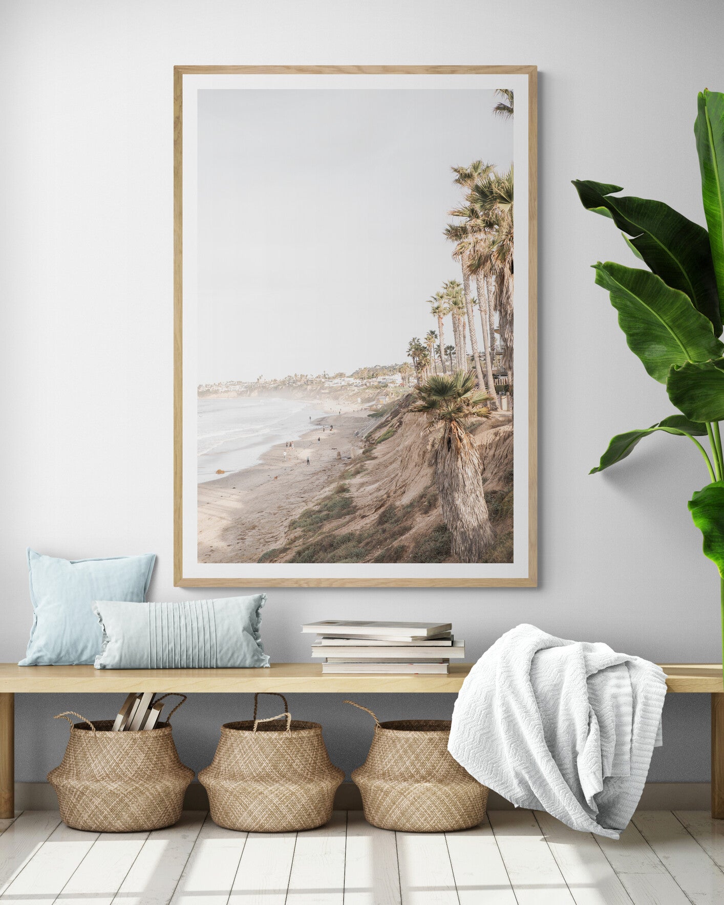 Vertical California coast print featuring a high vantage point overlooking Pacific Beach, with tall palm trees, a sandy beach, and the ocean. This coastal print offers a beautiful seascape. Photograph in minimalist mock up.