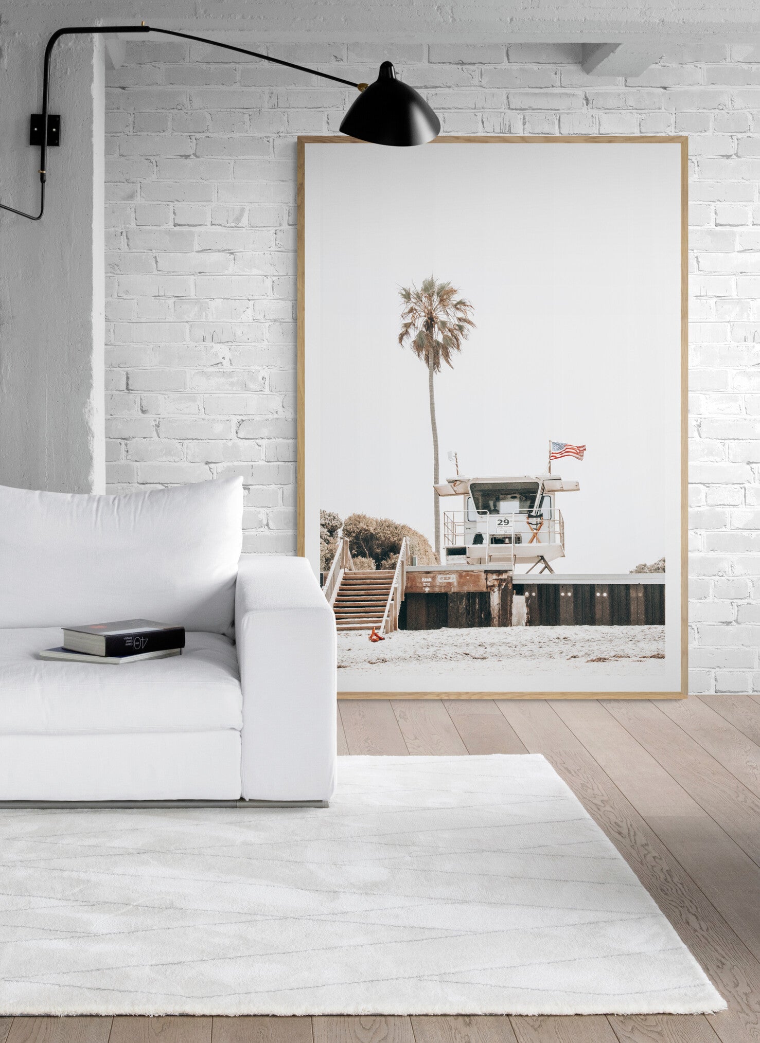 A photograph featuring an American flag on a lifeguard tower with a palm tree in the background, taken at a beach in Del Mar, San Diego. Photograph in minimalist mock up.