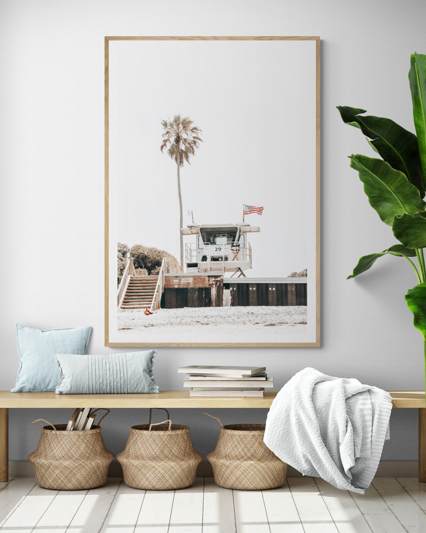 A photograph featuring an American flag on a lifeguard tower with a palm tree in the background, taken at a beach in Del Mar, San Diego. Photograph in minimalist mock up.