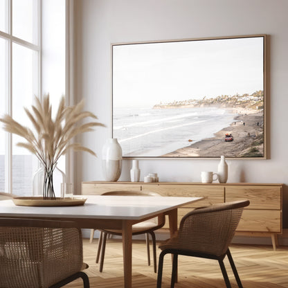Landscape surf wall decor at Pacific Beach, San Diego, with numerous surfers in the water and a residential cliffside. Photograph in minimalist mock up.