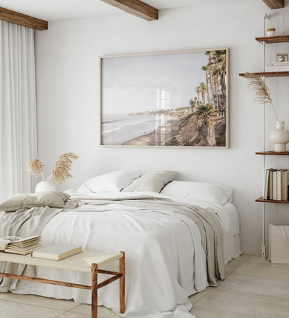 Horizontal, California coast print featuring a high vantage point overlooking Pacific Beach, with tall palm trees, a sandy beach, and the ocean. This coastal print offers a beautiful seascape. Photograph in minimalist mock up.