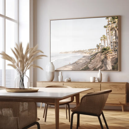 Horizontal, California coast print featuring a high vantage point overlooking Pacific Beach, with tall palm trees, a sandy beach, and the ocean. This coastal print offers a beautiful seascape. Photograph in minimalist mock up.