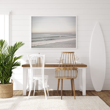 A wide landscape surf wall decor shot of Pacific Beach, showing many surfers in the water catching gentle waves under a hazy sky. This neutral surf print is great for beach art. Photograph in minimalist mock up.