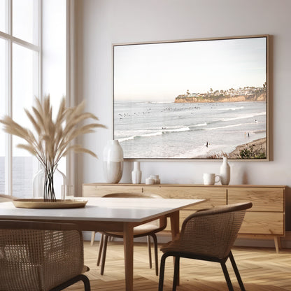 Landscape surf wall decor at Tourmaline Surf Park, Pacific Beach, San Diego, with numerous surfers in the water and a residential cliffside. Photograph in minimalist mock up.
