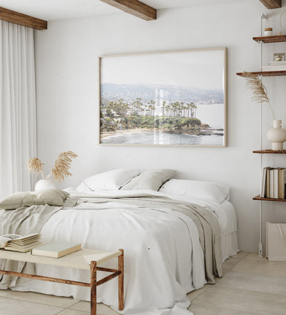 Horizontal coastal photography of Laguna Beach, San Diego, featuring a fine art giclee print featuring palm trees on a small island in a body of water. Photograph in minimalist mock up.