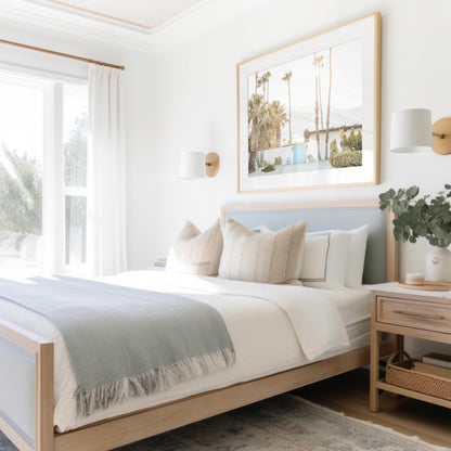Coastal print of a Palm Springs home with a bright blue door, surrounded by tall palm trees and distant mountains, embodying summer vibes wall art. Photograph in minimalist mock up.