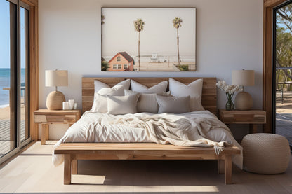 Landscape beach photography of Oceanside, California, highlighting a beachfront house and a lifeguard tower with two tall palm trees and the ocean. Photograph in minimalist mock up.