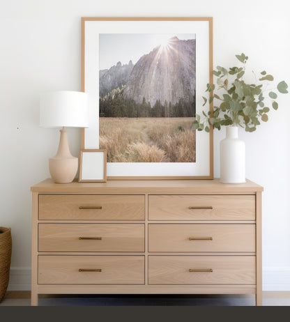 Fine art Yosemite Valley landscape print by Southern California photographer Kim Dybczak of Salt Creek Prints, featuring a golden field and granite cliffs with sunlight streaming over the mountains. Photograph in minimalist mock up
